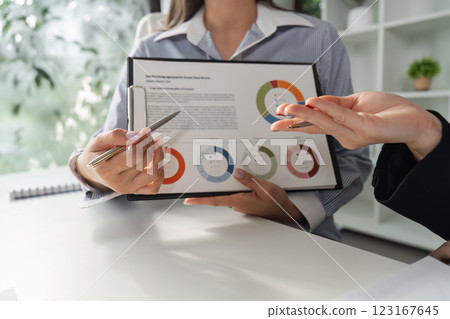 Financial professionals analyzing data and discussing strategies in a collaborative setting. 123167645