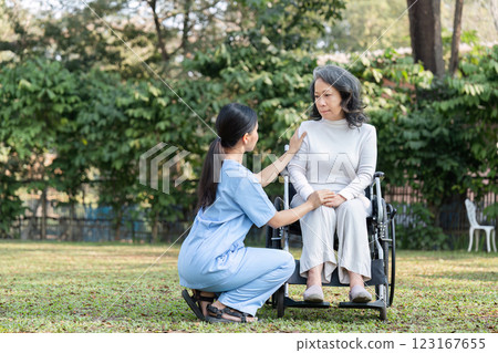 Nurse and Elderly Patient Enjoying a Peaceful Moment in the Garden with a Wheelchair 123167655