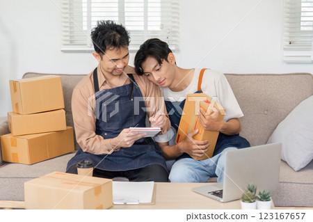 LGBT couple collaborating on online sales, sharing ideas while packing items at home 123167657