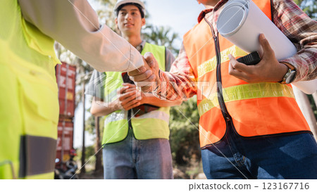 Engineers sealing a deal with a handshake construction professionals collaborating on a project Engineers sealing a deal with a handshake construction professionals collaborating on a project 123167716