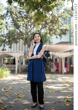 Confident Businessman Engaged in a Phone Conversation Outdoors in a Modern Urban Setting 123167717