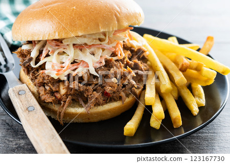 Pulled pork sandwich with coleslaw salad on wooden table 123167730