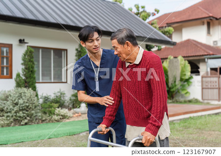 Nurse providing emotional support to elderly man with walker in a serene garden setting 123167907