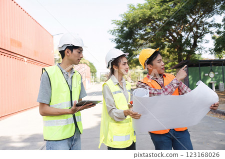 Construction professionals analyzing blueprints and planning at an active construction site Construction professionals analyzing blueprints and planning at an active construction site 123168026