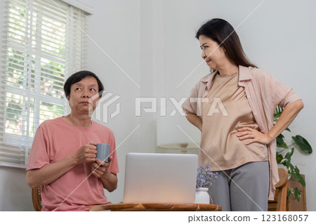 Diverse couple interacting playfully in a modern home office setting. Diverse couple interacting playfully in a modern home office setting. 123168057