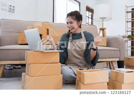 Small business owner celebrates success with successful online shopping business Small business owner celebrates success with successful online shopping business 123168127