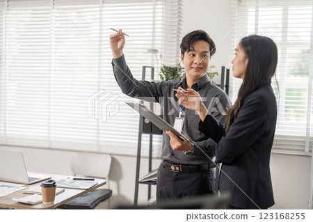 Business professionals celebrating success in modern office, showcasing teamwork and collaboration. 123168255