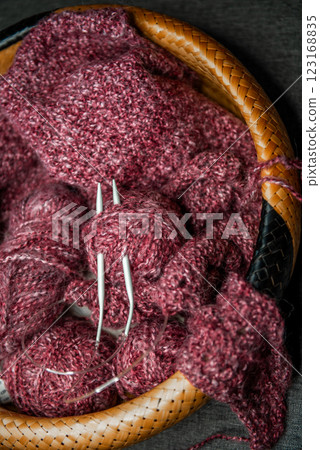 yarns, knitting needles and pattern sample in basket on sofa. yarns, knitting needles and pattern sample in basket on sofa. 123168835
