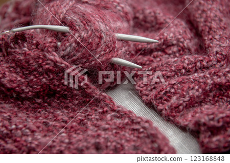 yarns, knitting needles and pattern sample on grey background. 123168848
