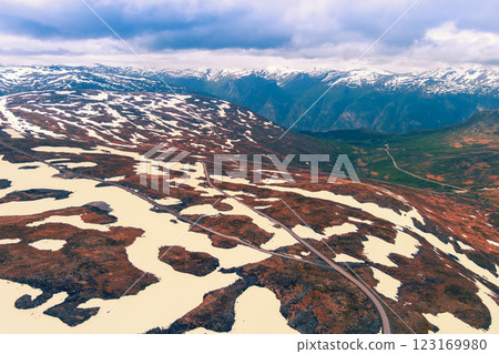 Aerial view of snow covered mountain in summer. High mountain road Bjorgavegen. Aurlandsvegen, Aurland, Norway Aerial view of snow covered mountain in summer. High mountain road Bjorgavegen. Aurlandsvegen, Aurland, Norway 123169980