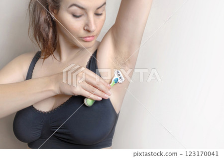 Woman showing natural body hair without shaving. Hairy woman. She doesn't like it cropped close up photo 123170041