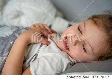 Cute little girl sleeping and grinding teeth in dreams, clenched teeth with tiredness and stress  123170064