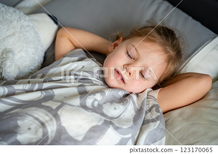 Cute little girl sleeping and grinding teeth in dreams, clenched teeth with tiredness and stress  123170065