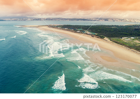 Aerial view of seascape in the evening. Seacoast of Costa da Caparica city. View of Lisbon. Almada, Portugal Aerial view of seascape in the evening. Seacoast of Costa da Caparica city. View of Lisbon. Almada, Portugal 123170077