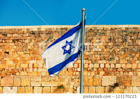 The Israeli flag flies at the Western Wall in Jerusalem in Israel The Israeli flag flies at the Western Wall in Jerusalem in Israel 123170225
