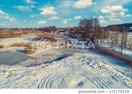 Aerial view of the countryside and frozen winding brook on a sunny day. Beautiful nature landscape Aerial view of the countryside and frozen winding brook on a sunny day. Beautiful nature landscape 123170239