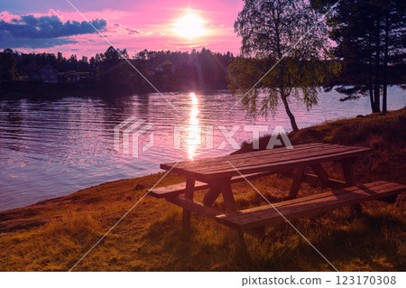 Place for rest and relax on lakeshore with wooden table and benches. View of Mjosa lake. Beautiful nature of Norway, Europe Place for rest and relax on lakeshore with wooden table and benches. View of Mjosa lake. Beautiful nature of Norway, Europe 123170308