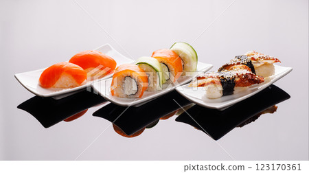 Assorted sushi and maki rolls beautifully arranged on plates Assorted sushi and maki rolls beautifully arranged on plates 123170361