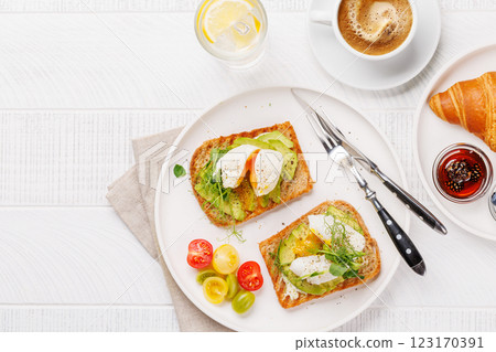 Breakfast with delicious avocado toasts and crispy croissant Breakfast with delicious avocado toasts and crispy croissant 123170391