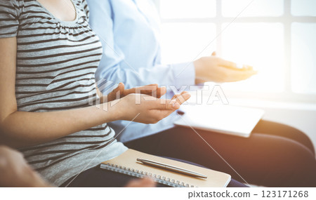 Business people clapping at meeting or conference, close-up of hands. Group of unknown businessmen and women in sunny office Business people clapping at meeting or conference, close-up of hands. Group of unknown businessmen and women in sunny office 123171268