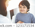 Doctor-woman examining a child patient by stethoscope in sunny clinik. Medicine concept 123171534