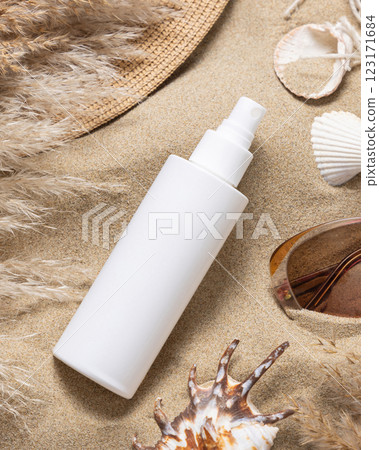 White spray bottle, sunglasses, pampas grass and seashells on a sand, Sunscreen cosmetic mockup 123171684