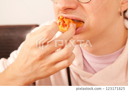 Bearded Caucasian white mature male in pink t-shirt eating delicious pizza slices Bearded Caucasian white mature male in pink t-shirt eating delicious pizza slices 123171825