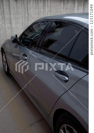 Side view of a luxury gray sedan model car from 2024 production, folding mirror details 123171849
