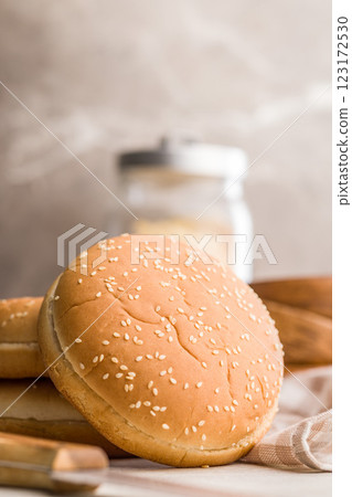Empty burger bun with sesame seeds on kitchen table. Empty burger bun with sesame seeds on kitchen table. 123172530