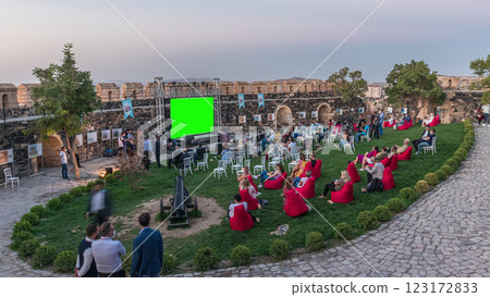People are enjoying the open air cinema in the hictoric building at evening timelapse People are enjoying the open air cinema in the hictoric building at evening timelapse 123172833