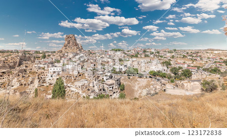View of Ortahisar town old houses in rock formations from Ortahisar Castle aerial timelapse. 123172838