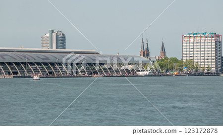 Close up view of Amsterdam Central Station with its curved roof and the Amstel River timelapse. Amsterdam, Netherlands Close up view of Amsterdam Central Station with its curved roof and the Amstel River timelapse. Amsterdam, Netherlands 123172878