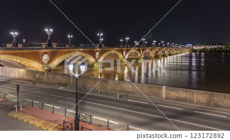 Pont de Pierre stone bridge with Porte de Bourgogne night timelapse in Bordeaux, France. Pont de Pierre stone bridge with Porte de Bourgogne night timelapse in Bordeaux, France. 123172892