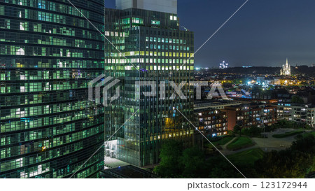 Aerial night timelapse of modern skyscrapers and towers in Brussels with glass facades and glowing windows. Belgium Aerial night timelapse of modern skyscrapers and towers in Brussels with glass facades and glowing windows. Belgium 123172944