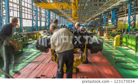 Conveyor assembly stage the body of tractor at big industrial factory timelapse Conveyor assembly stage the body of tractor at big industrial factory timelapse 123173034