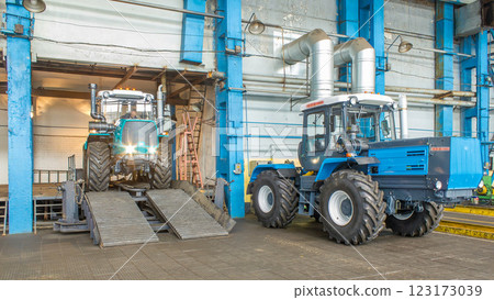 Conveyor assembly final stage of tractor at factory timelapse Conveyor assembly final stage of tractor at factory timelapse 123173039