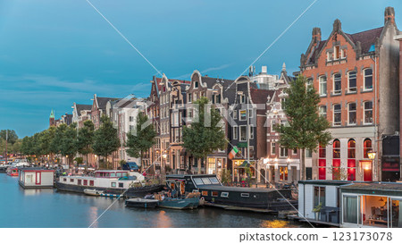 Panoramic timelapse hyperlapse of the illuminated famous Dancing Houses along the Amstel River day to night transition. Amsterdam, Netherlands Panoramic timelapse hyperlapse of the illuminated famous Dancing Houses along the Amstel River day to night transition. Amsterdam, Netherlands 123173078