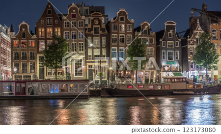 Panoramic timelapse of the illuminated famous Dancing Houses along the Amstel River at night. Amsterdam, Netherlands Panoramic timelapse of the illuminated famous Dancing Houses along the Amstel River at night. Amsterdam, Netherlands 123173080