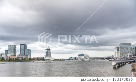 Panoramic view of Amsterdam skyline featuring A'dam Lookout Tower and Eye Film Museum in timelapse. Netherlands Panoramic view of Amsterdam skyline featuring A'dam Lookout Tower and Eye Film Museum in timelapse. Netherlands 123173086