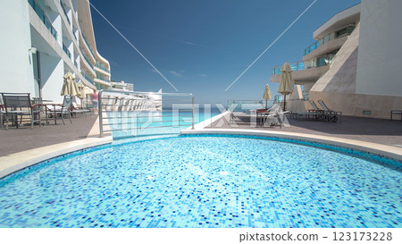 Hotel small swimming pool with sunny reflections timelapse, Sesimbra, Portugal 123173228