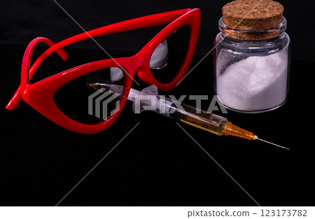 Red sunglasses and syringe and white powder on black background Red sunglasses and syringe and white powder on black background 123173782