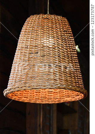 three rattan chandeliers different forms on white brick wall background. Straw lampshade in cozy living room. Eco-friendly interior design using natural materials. Scandinavian interior. 123173787