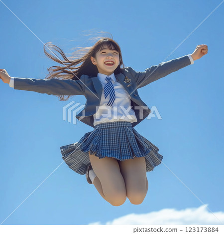 A high school girl in uniform jumps in joy after passing the university entrance exam 123173884