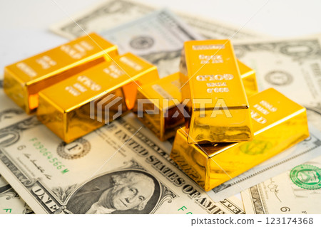 Gold bars with US dollar banknote money, finance trading investment business currency. 123174368