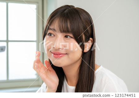 Young woman checking her skin Young woman checking her skin 123174451
