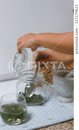 Preparing dried moringa leaves or moringa oleifera to make tea, a traditional natural alternative medicine and health supplement Preparing dried moringa leaves or moringa oleifera to make tea, a traditional natural alternative medicine and health supplement 123174621
