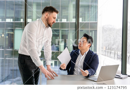 Professional Discussion Between Two Businessmen in a Modern Office Setting Professional Discussion Between Two Businessmen in a Modern Office Setting 123174795