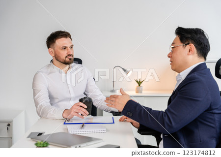 Professional Business Meeting Between Two Individuals in a Modern Office Setting 123174812