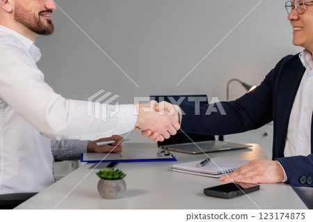 Professional Handshake Between Businessmen in Modern Office Setting Professional Handshake Between Businessmen in Modern Office Setting 123174875