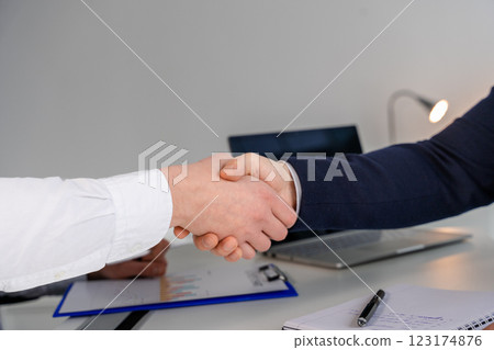 Professional Handshake Between Two Businesspeople in an Office Environment Professional Handshake Between Two Businesspeople in an Office Environment 123174876